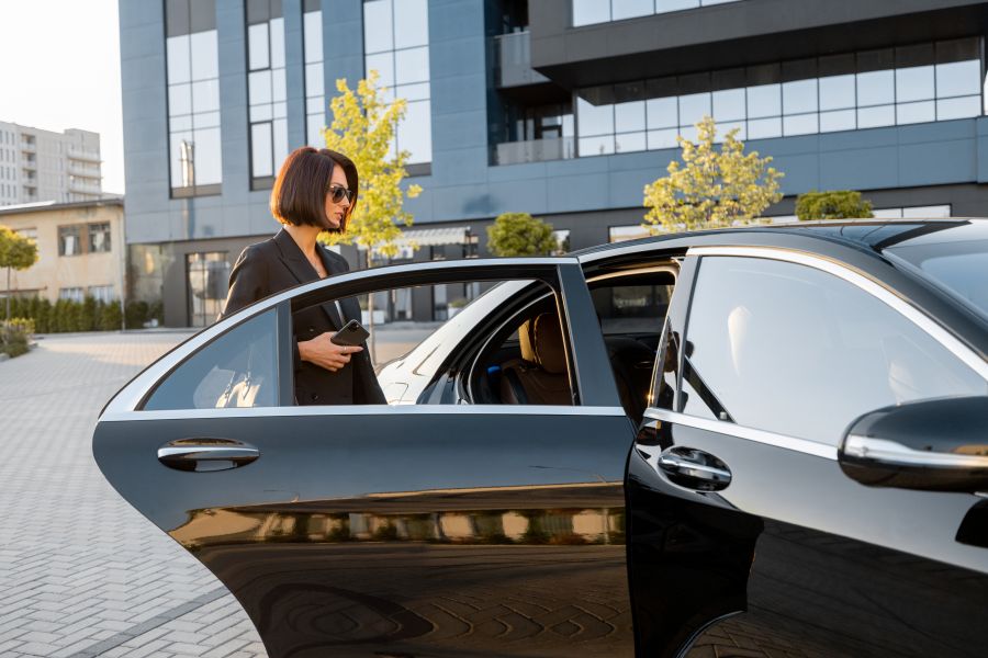 professional woman getting into black car outside 2026 03 24 07 23 48 utc