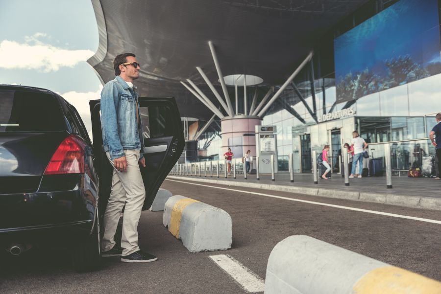 well dressed man at airport exits black car 2026 04 13 00 37 39 utc